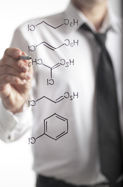 Man in shirt drawing chemical diagram